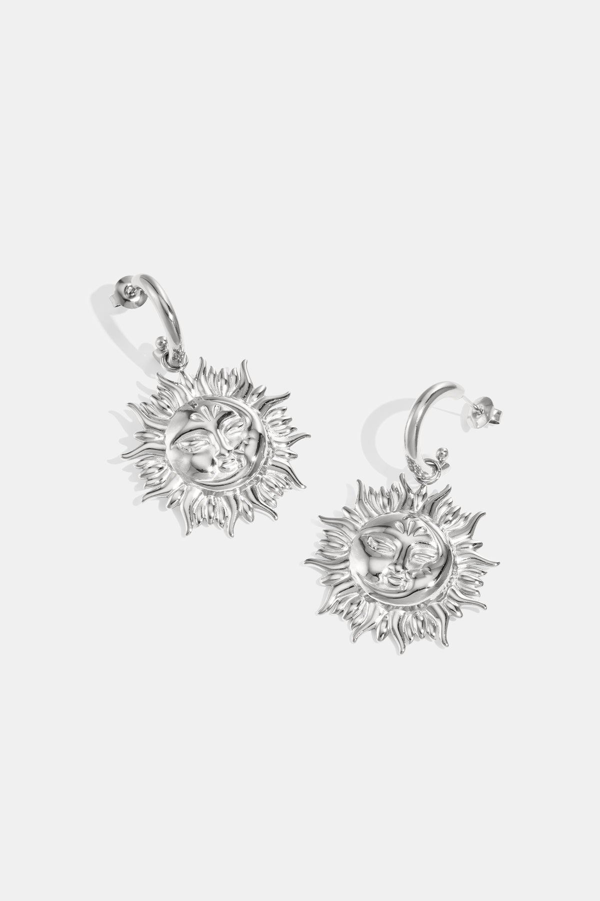 Silver drop earrings with sun motifs and faces.