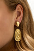 Gold irregular drop earrings with a spiral design.