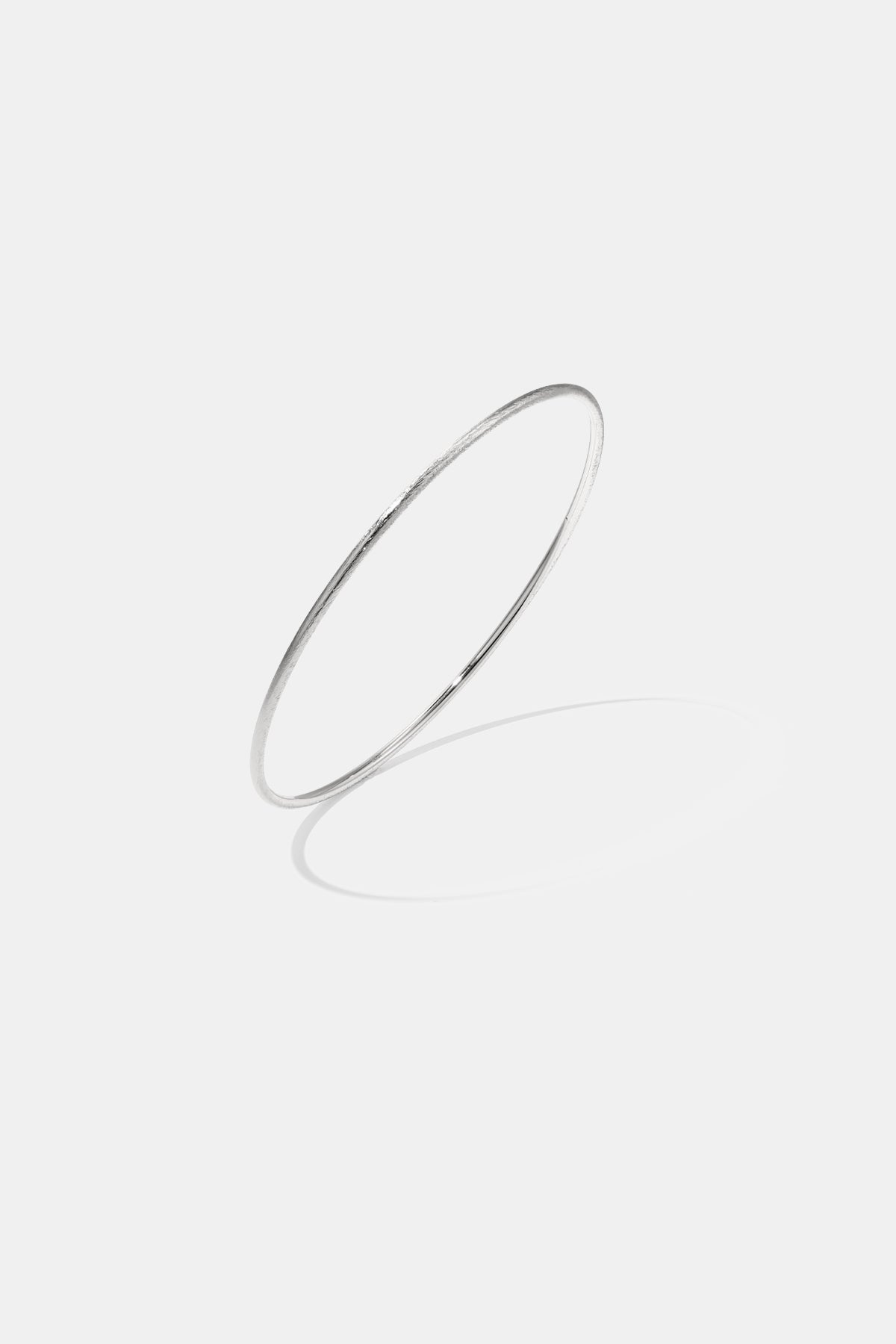 Elara Bangle Bracelet, 2 mm thick, brushed stainless steel with a subtle sheen.