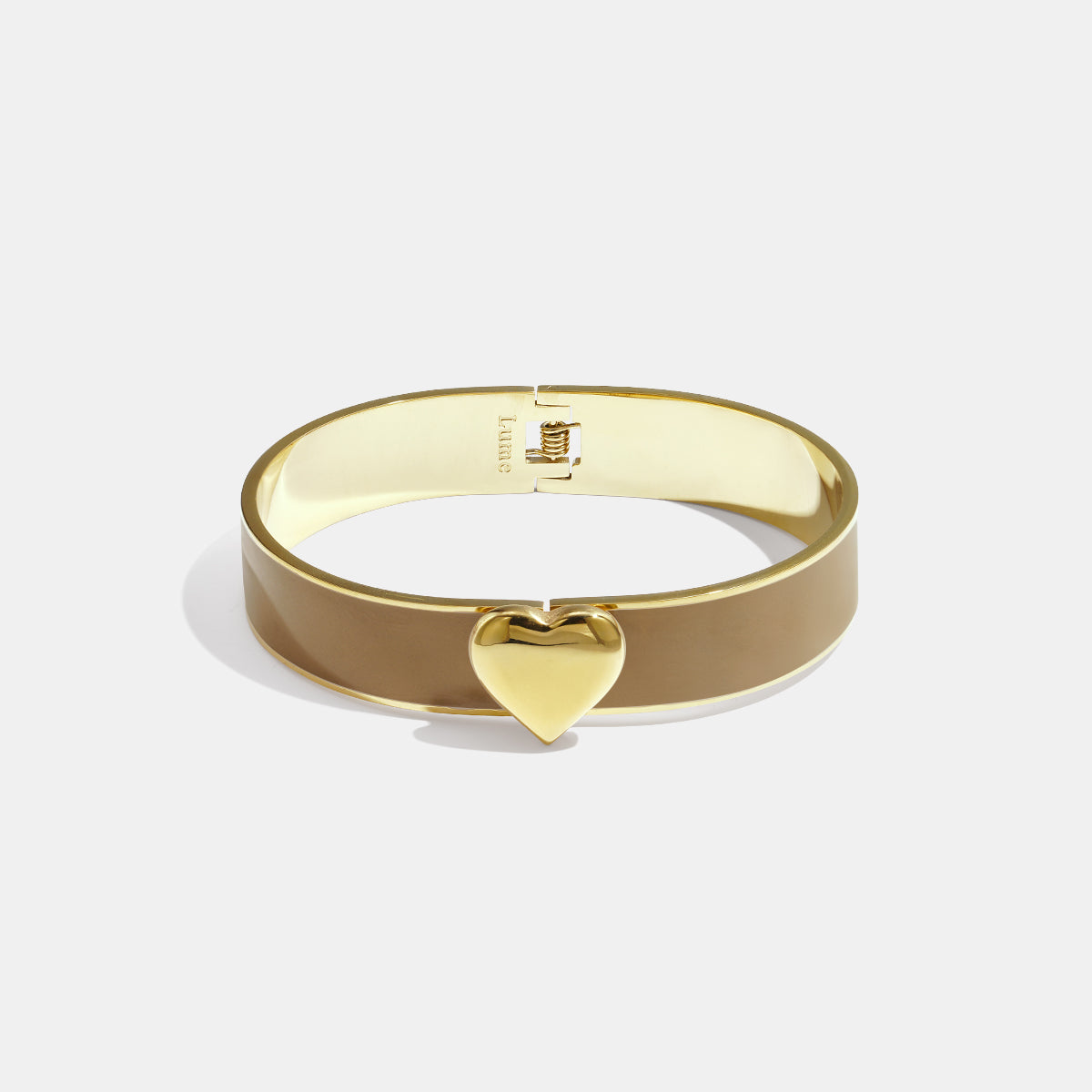 Khaki bangle bracelet with a gold heart charm and gold clasp.