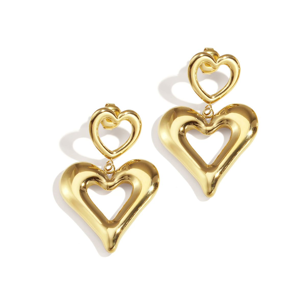 Gold heart drop earrings with a smaller heart stud.