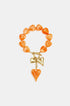 Orange heart-shaped beaded bracelet with gold heart charms and toggle clasp.