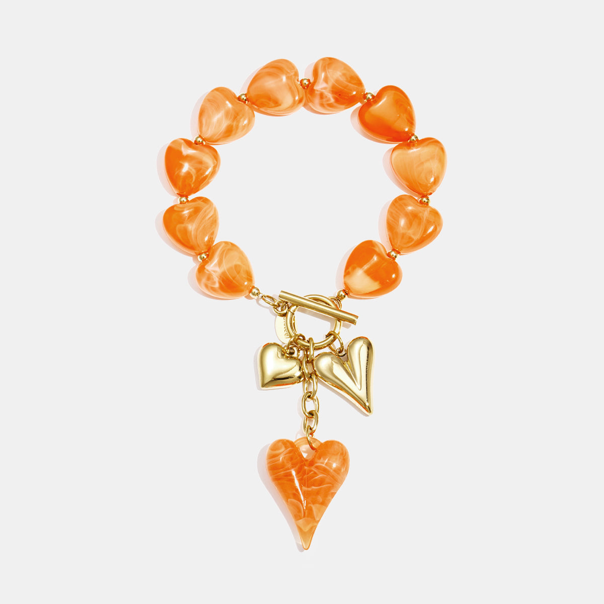 Orange heart-shaped beaded bracelet with gold heart charms and toggle clasp.