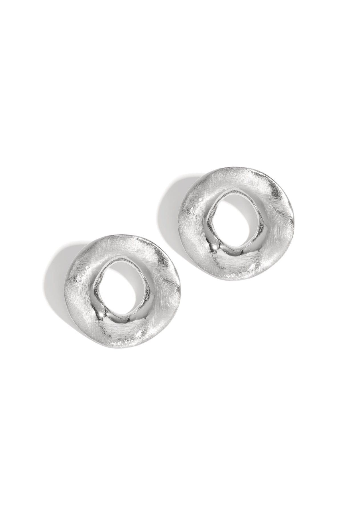 Two silver, textured, circular Aura Statement Earrings on a white background.