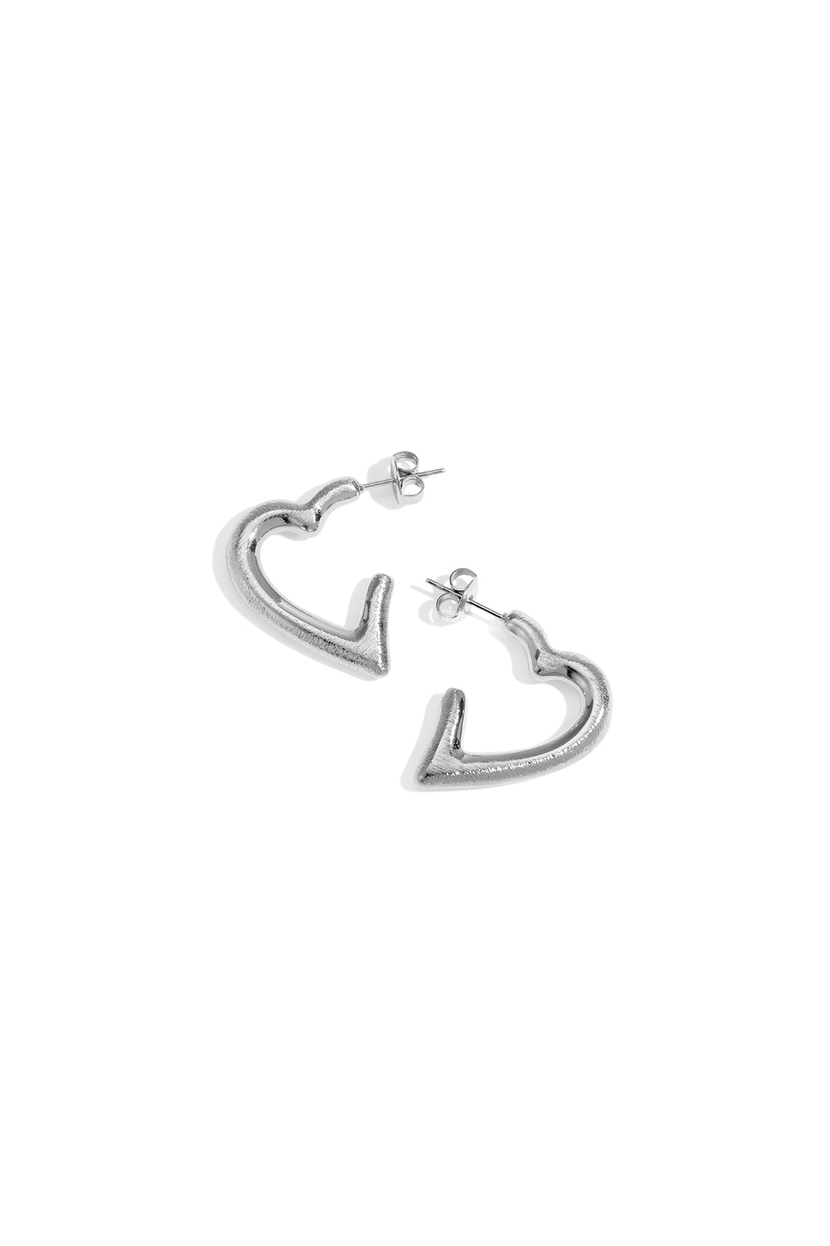 Silver heart hoop earrings with post backs, casting a shadow on a white background.