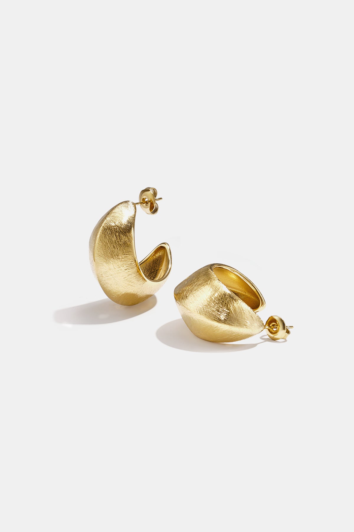 Aurelia Hoop Earrings in gold, featuring a textured, curved design.
