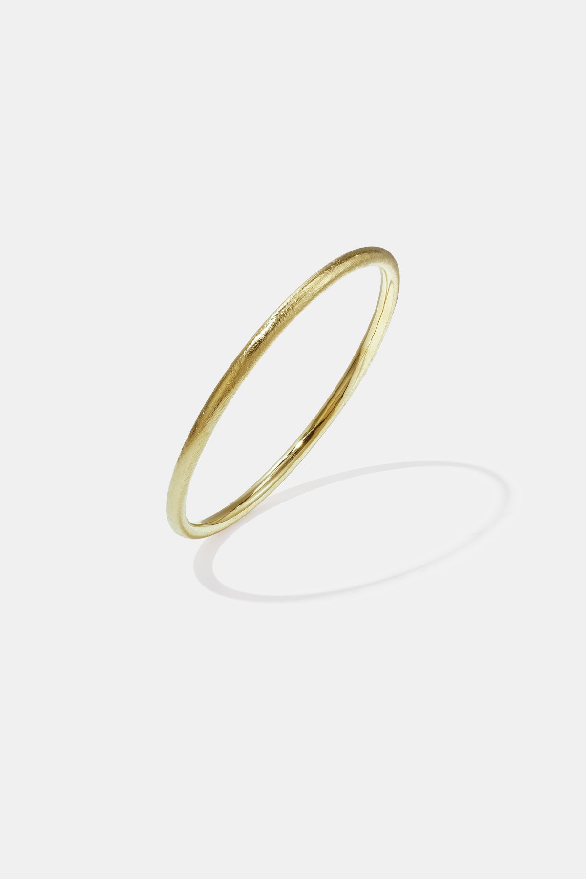 Gold Elara Bangle Bracelet with a brushed finish and 7 mm width.