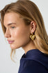 Gold heart drop earrings with a textured finish on a model.