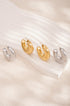 Two pairs of Elysian Hoop Earrings, one gold and one silver, with a brushed finish.