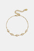 Gold geometric charm bracelet with five clear stones and beaded accents.