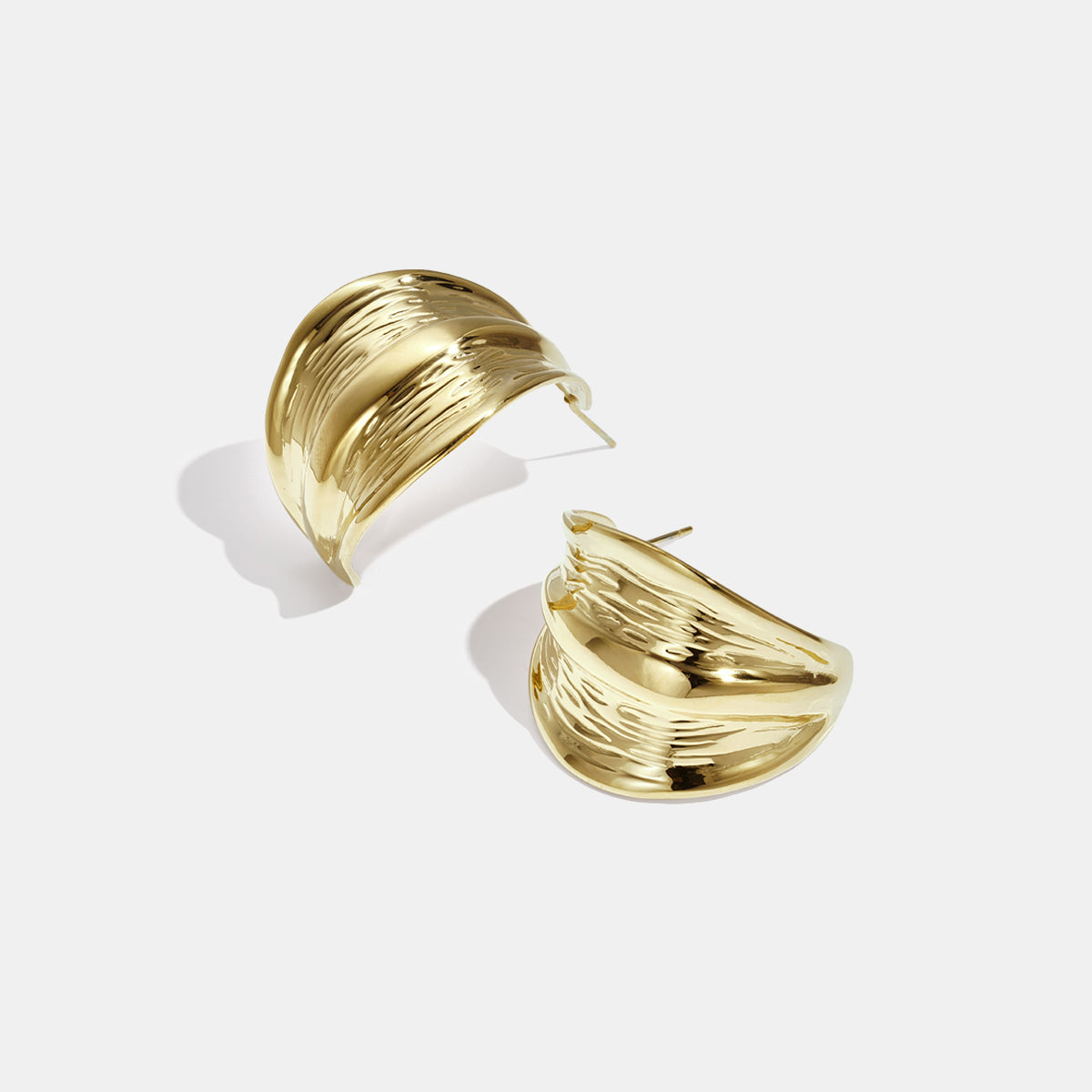 Gold Aurelia Hoop Earrings with a textured, wavy design.