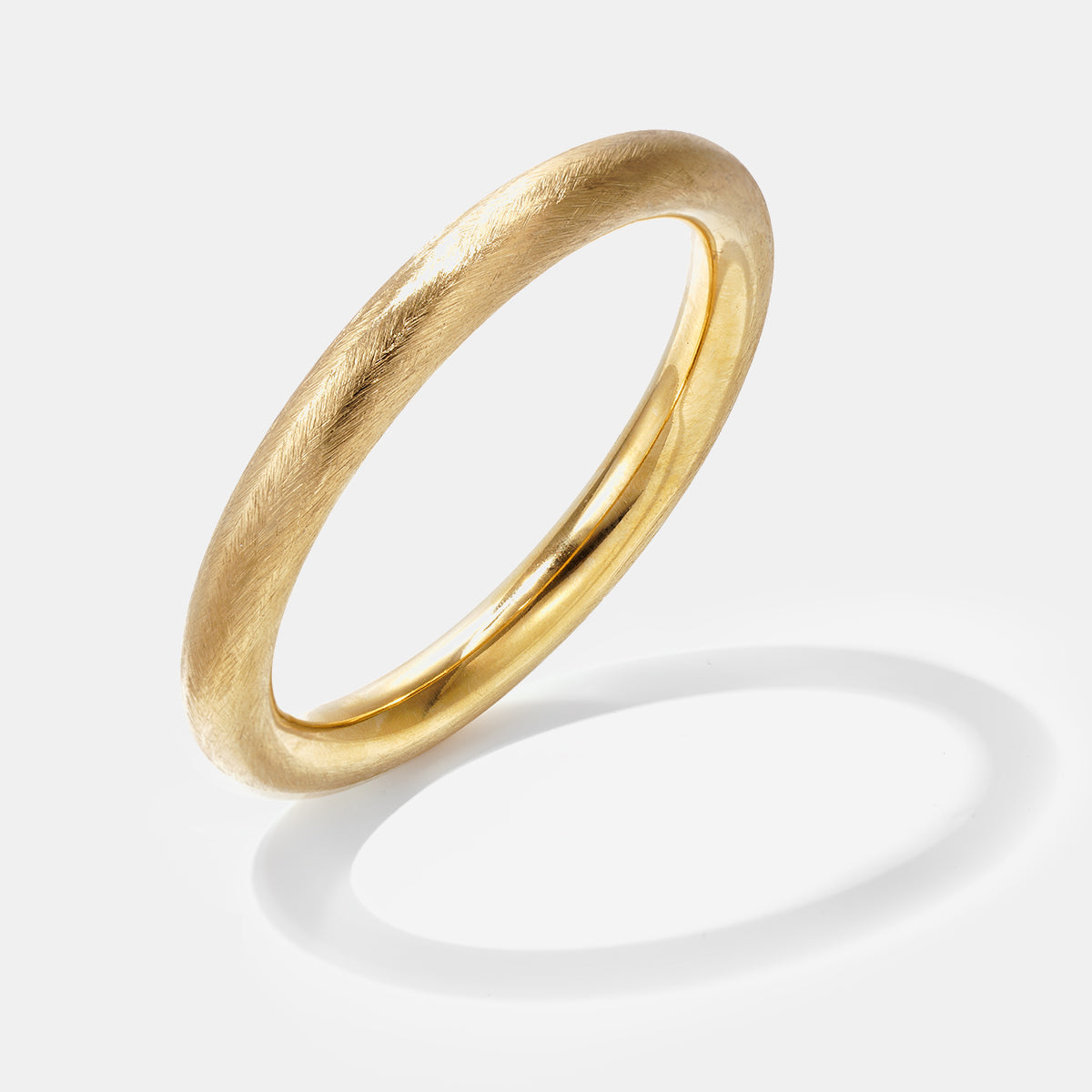 Elara Polished Bangle Bracelet in gold with a brushed finish.