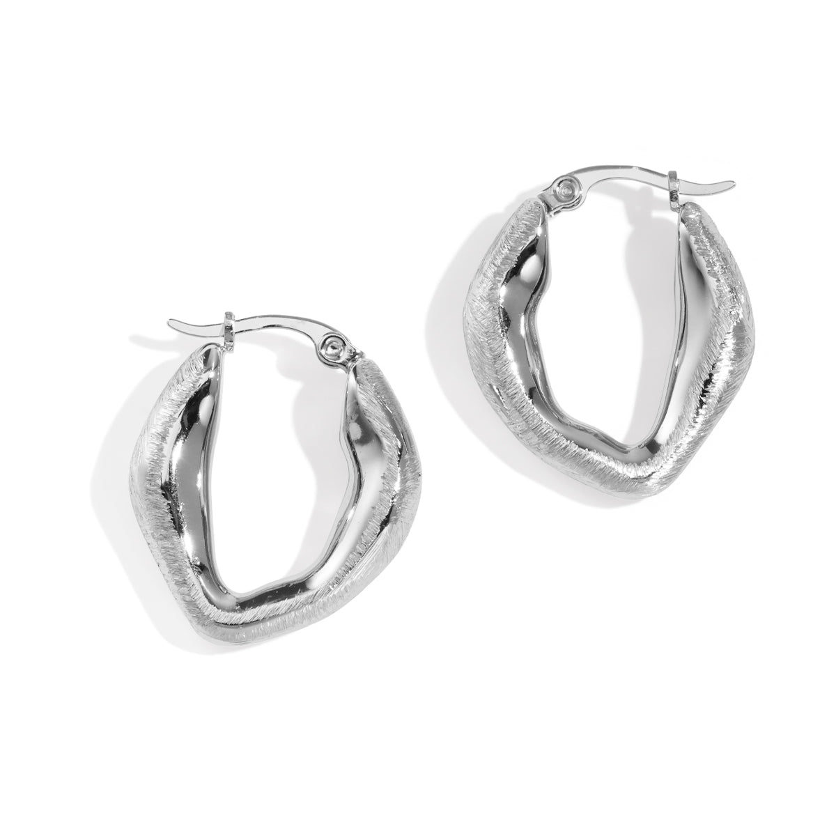 Aurelia Hoop Earrings: a pair of silver, textured, oval-shaped hoop earrings.
