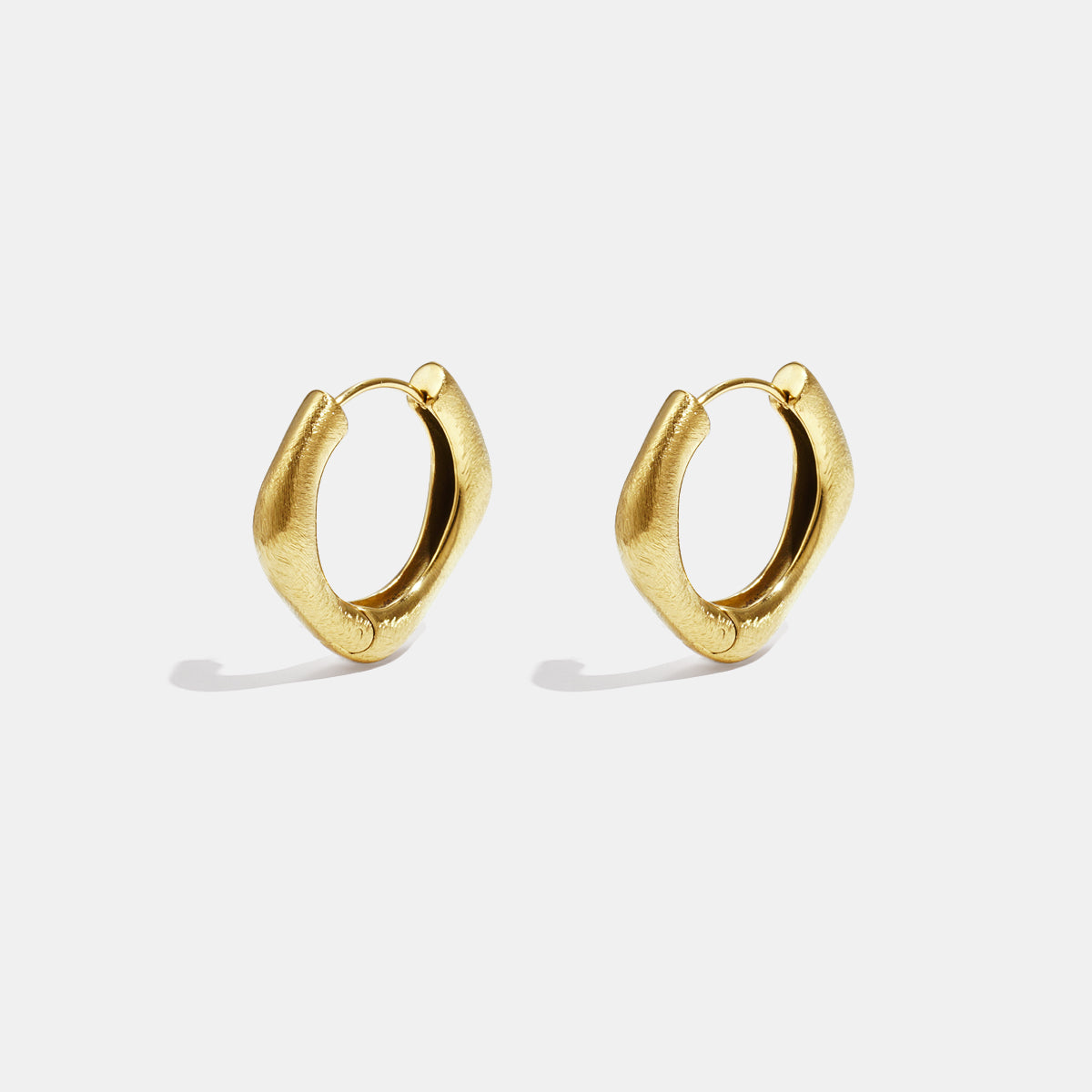 Pair of gold-colored stainless steel hoop earrings with a unique square shape and rounded edges.