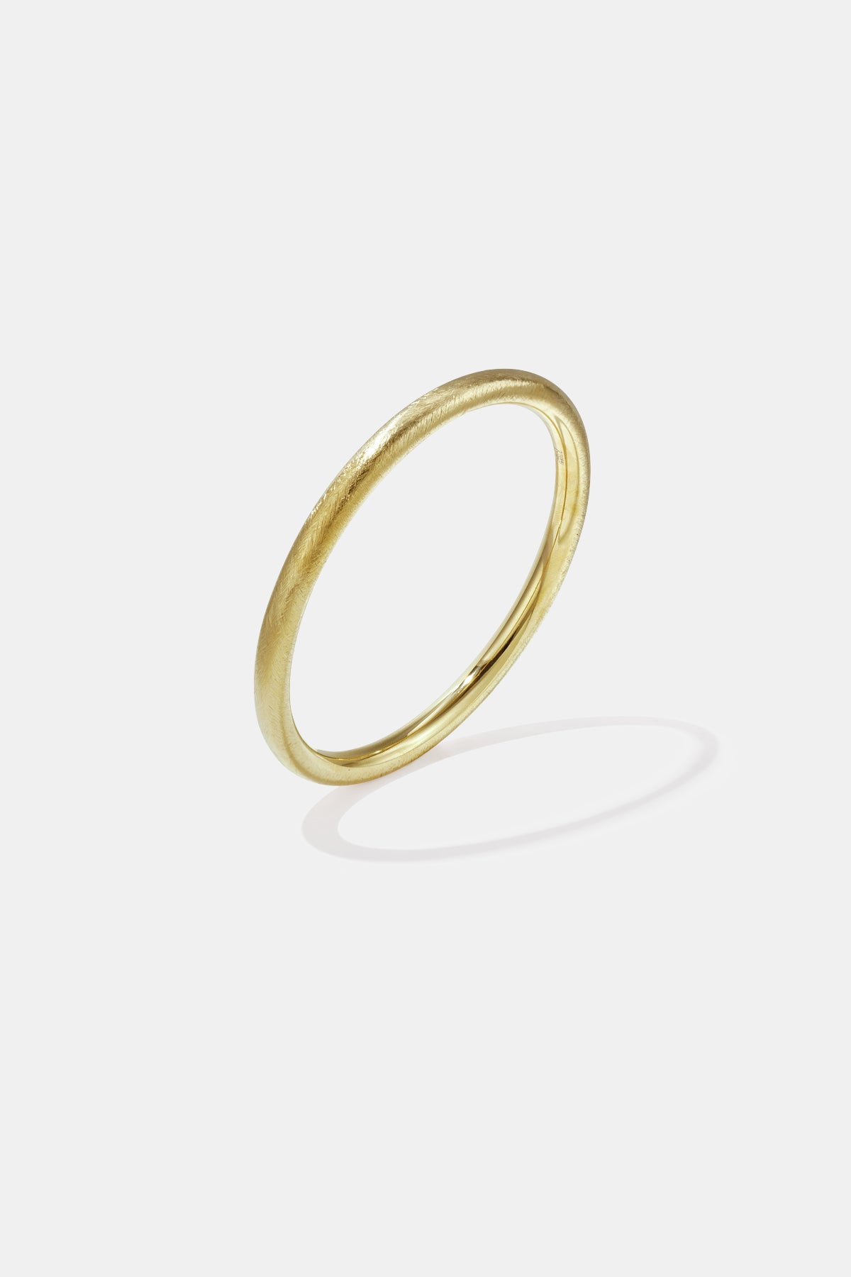 Elara Bangle Bracelet in gold with a brushed finish, 6 mm wide.