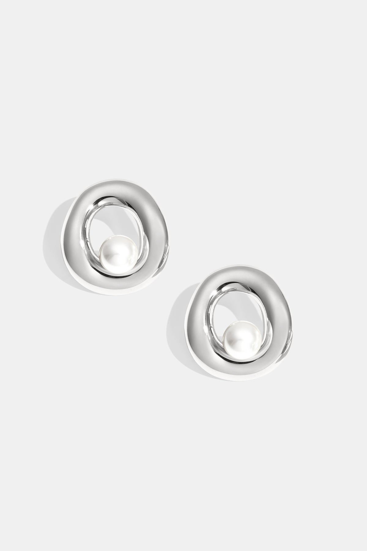 Silver Elysian Circle Stud Earrings with a pearl accent.