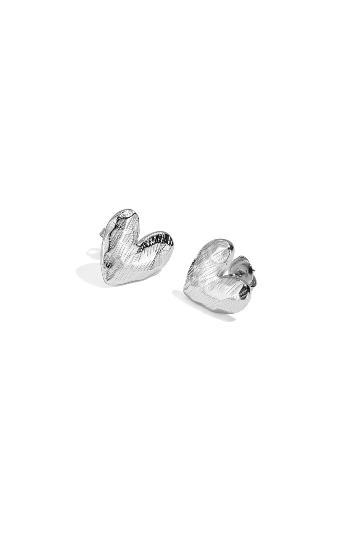 Silver heart-shaped stud earrings with a textured finish.