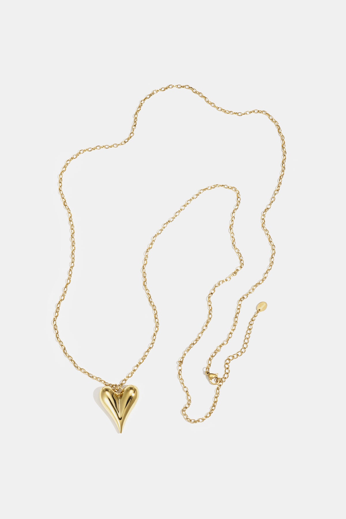 Gold heart pendant necklace with a long chain and clasp closure.