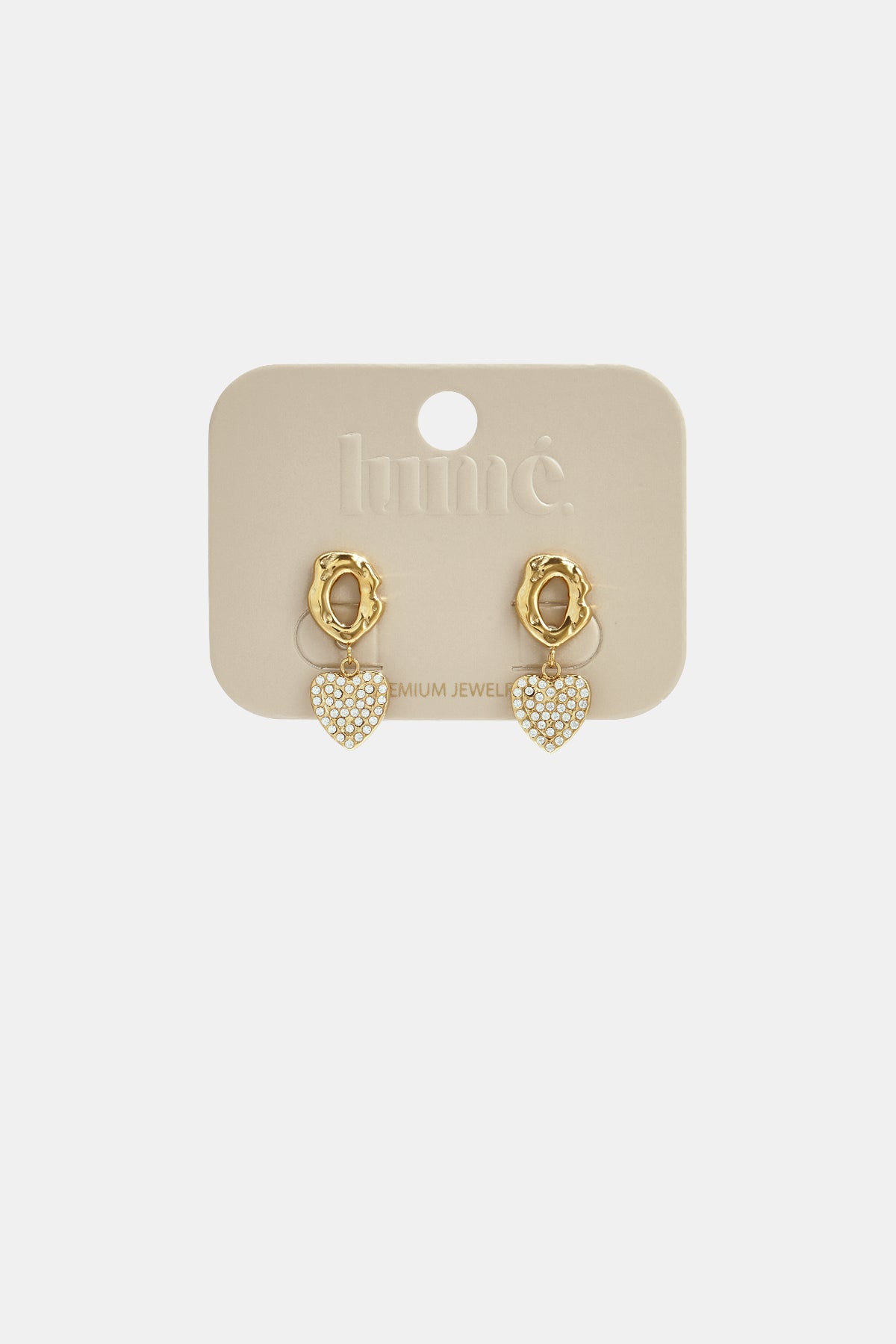 Gold heart drop earrings with zircon details on a beige card.