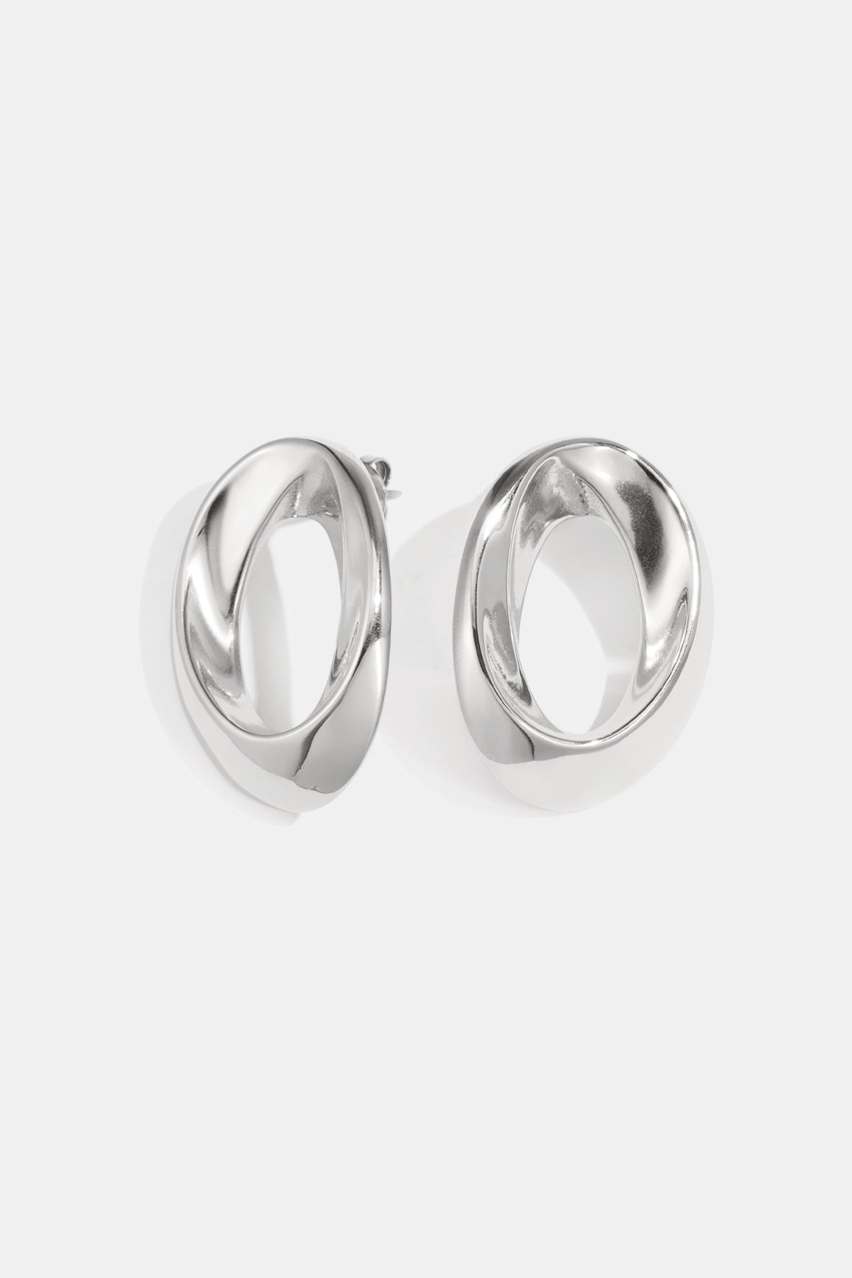 Aurelia Circle Stud Earrings in silver, featuring a twisted, open circle design.
