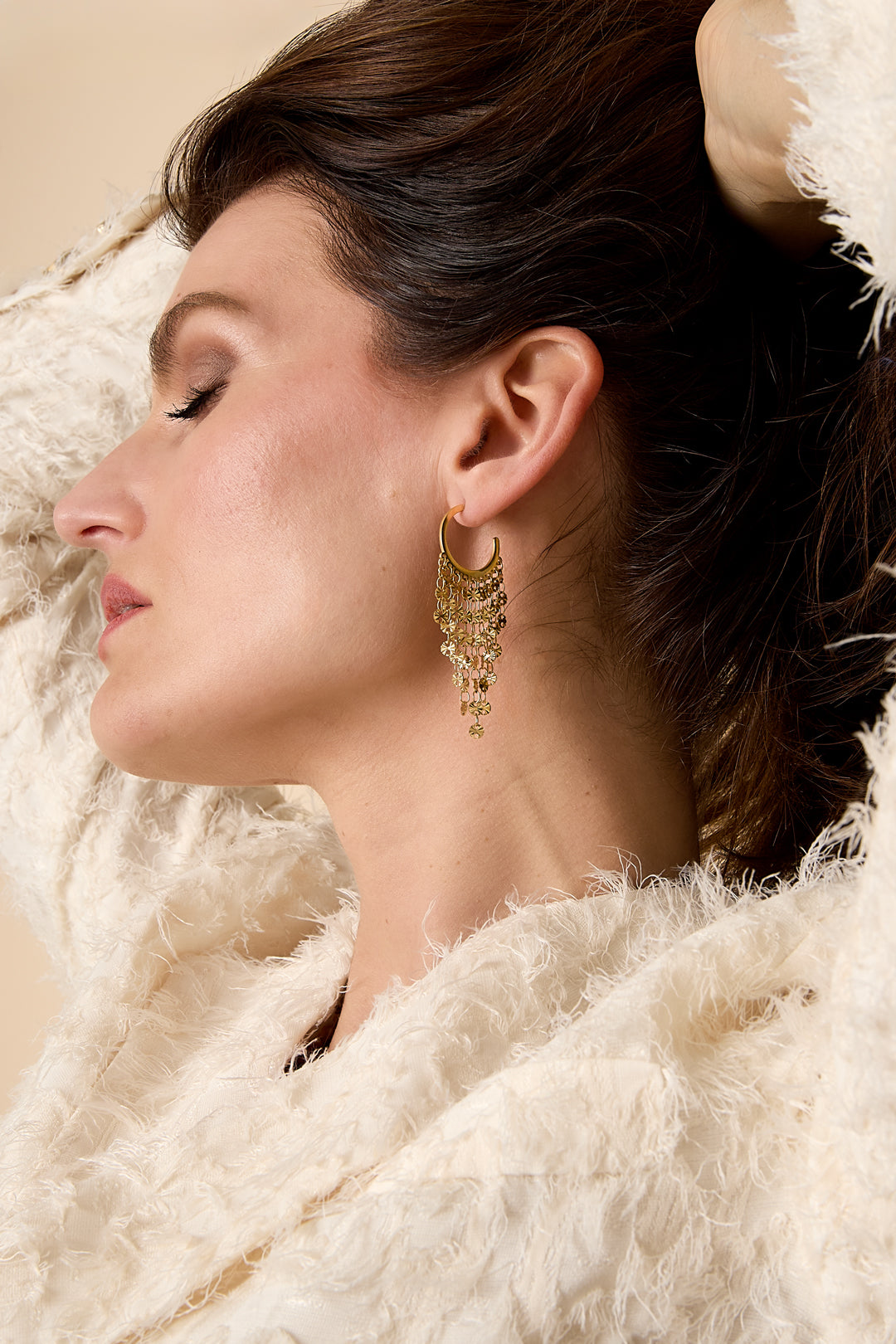 Gold tassel dangle earrings with multiple layers of delicate tassels.