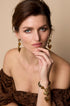 Gold-tone earrings with dangling amber-colored heart charms.