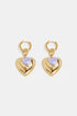 Gold hoop earrings with a large gold heart pendant and a small blue heart bead.