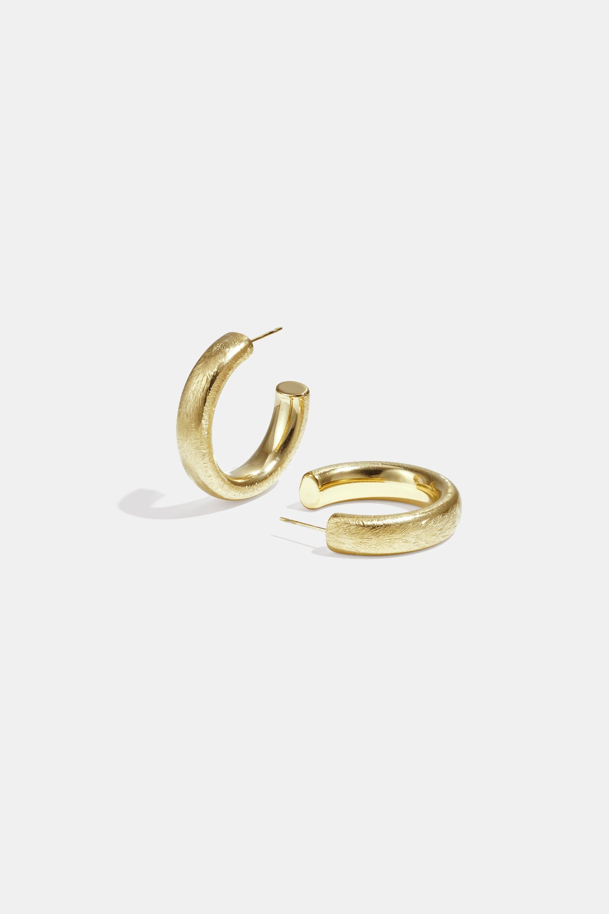 Aurelia Hoop Earrings in gold with a textured finish, displayed on a white background.