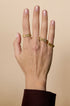 Gold-plated stainless steel ring with a minimalist rectangular design on a hand.