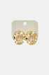Gold irregular shape stud earrings with a textured circular design on a light beige card.