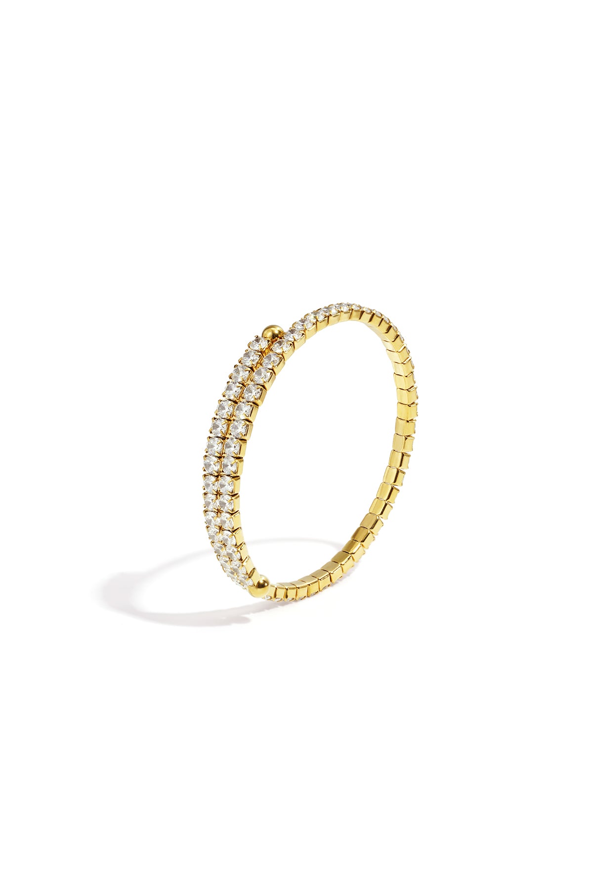 Gold cuff bracelet with two rows of clear rhinestones on a white background.