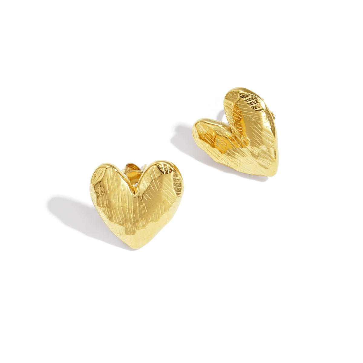 Gold heart-shaped stud earrings with a textured finish.