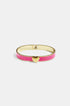 Gold bangle with pink enamel and a gold heart charm in the center.