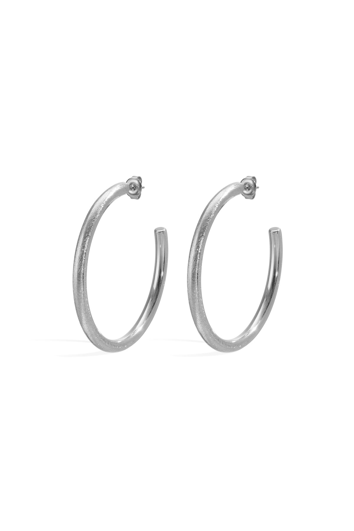 A pair of silver-toned hoop earrings with a textured finish, shown against a white background.
