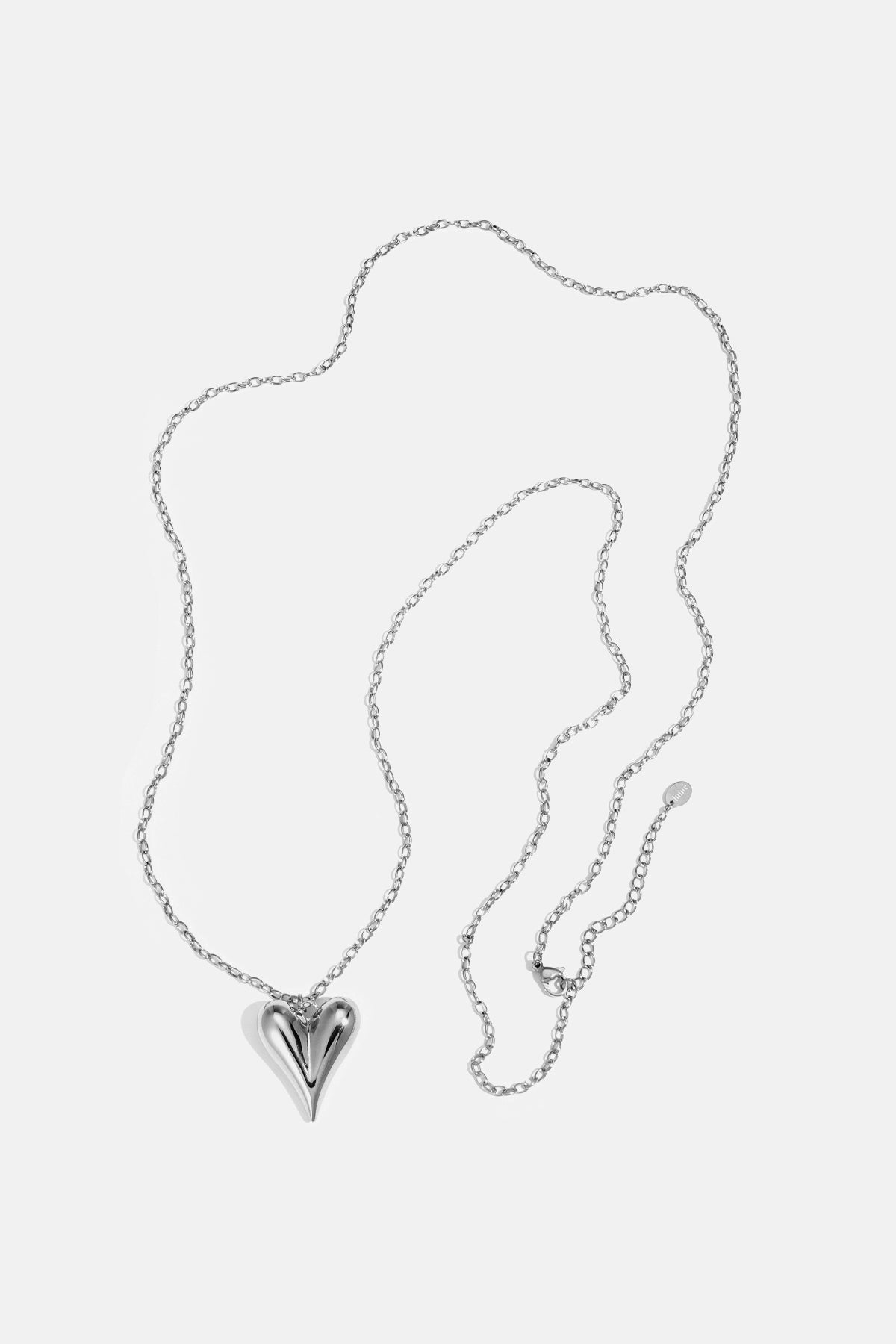 Silver heart pendant necklace with a long chain and a clasp closure.