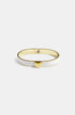Gold-tone bangle with white enamel and a gold heart charm.