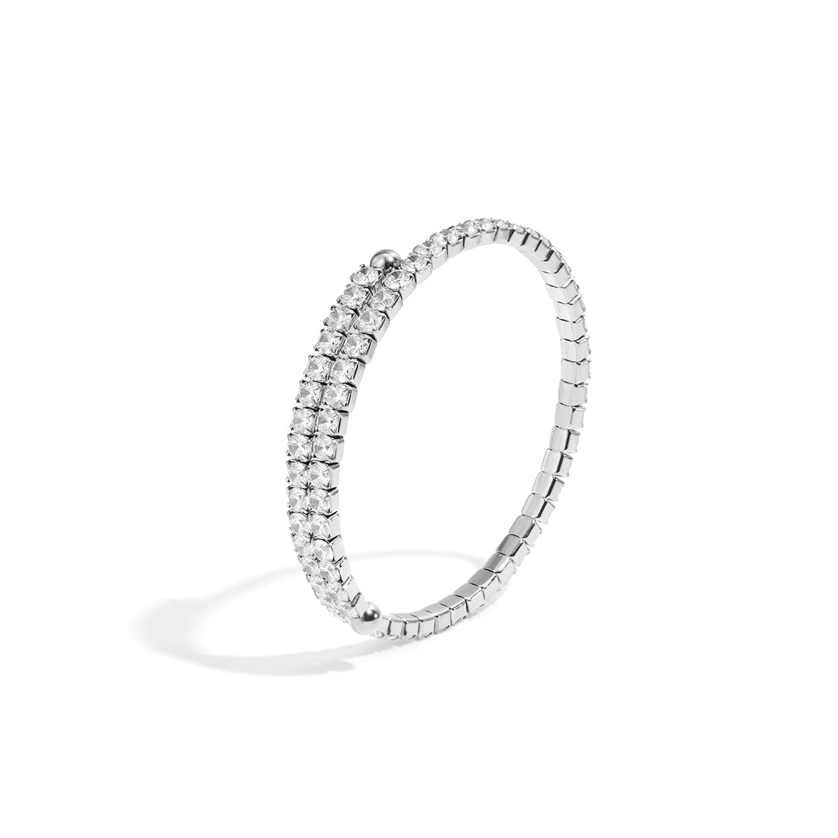 Silver cuff bracelet with two rows of clear rhinestones on a white background.