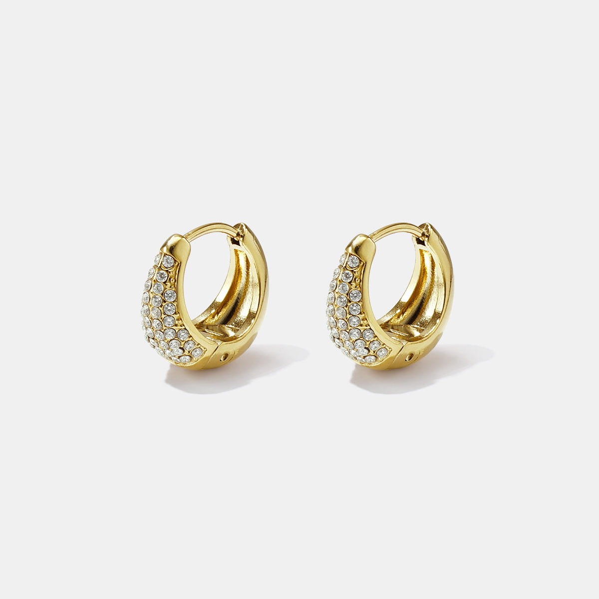 Gold hoop earrings adorned with clear rhinestones, presented as a pair.