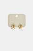 Gold hoop earrings with clear stones on a light beige card.