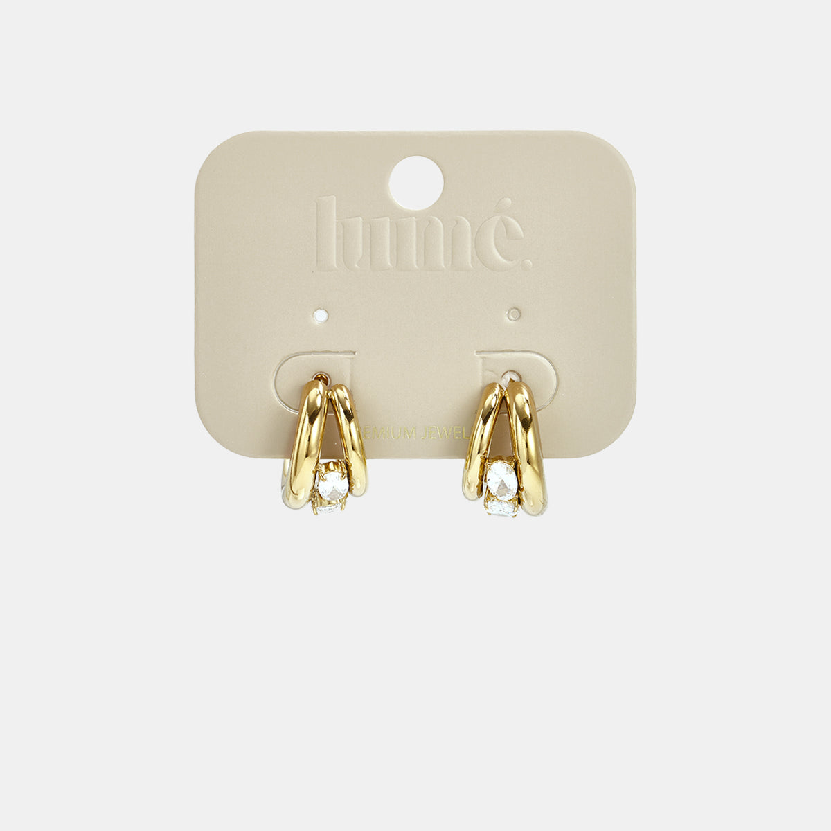 Gold hoop earrings with clear stones on a light beige card.