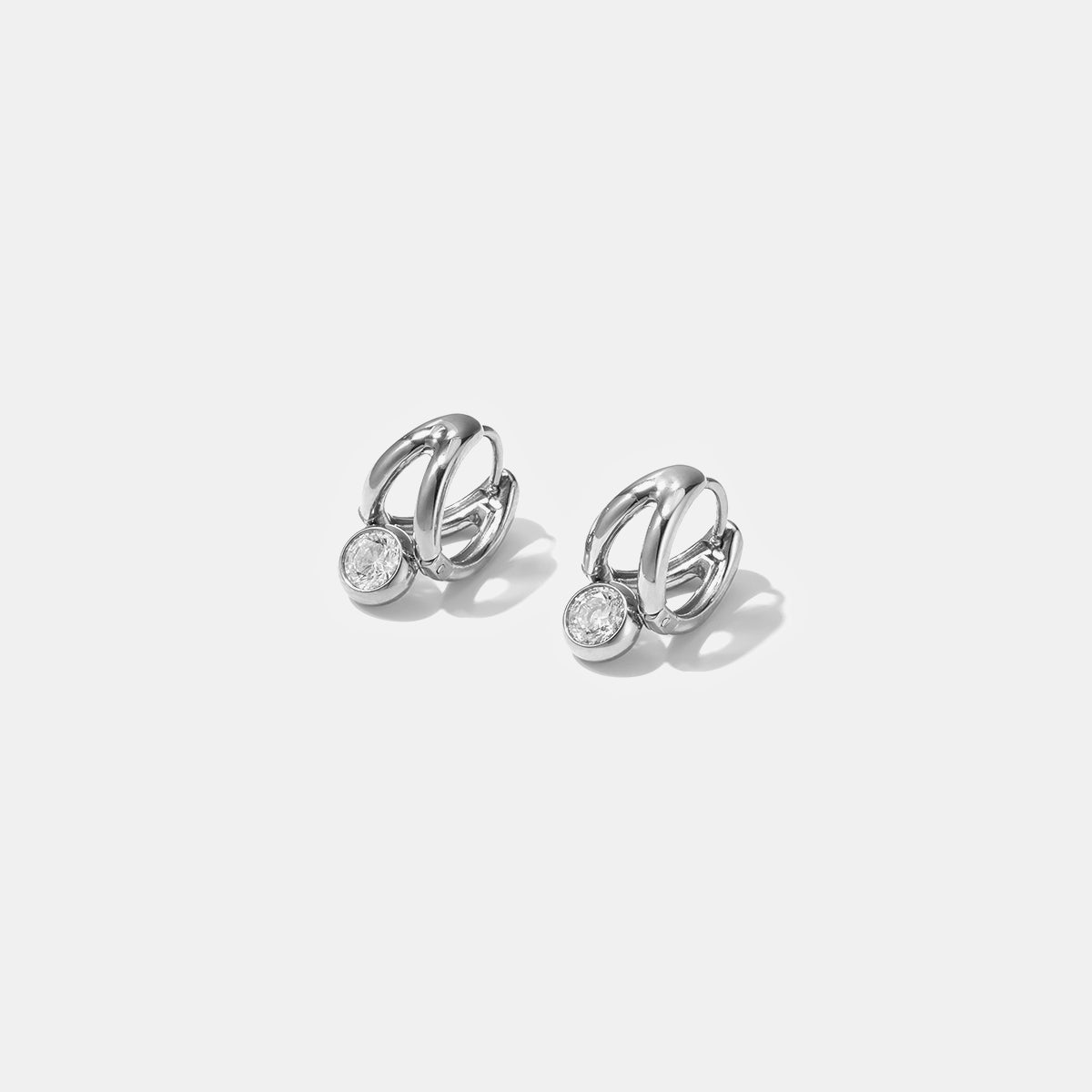 Ondine Irregular Hoop Earrings with a single clear stone on each.