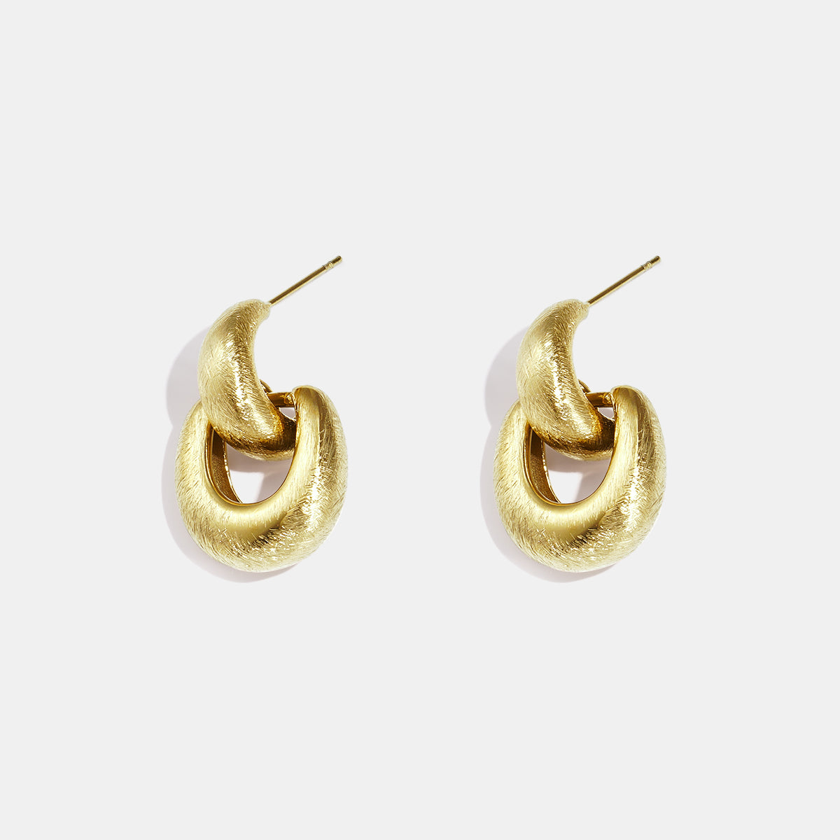 Pair of matte gold Elysian Link Earrings with a textured finish and post backing.