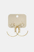 Gold hoop earrings with clear cubic zirconia stones on a beige card.