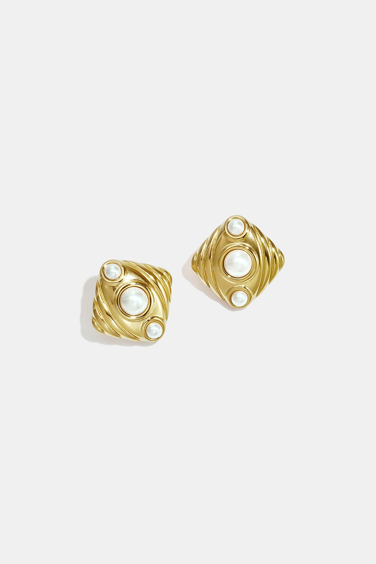 Gold Aurelia stud earrings with pearl accents and a textured geometric design.