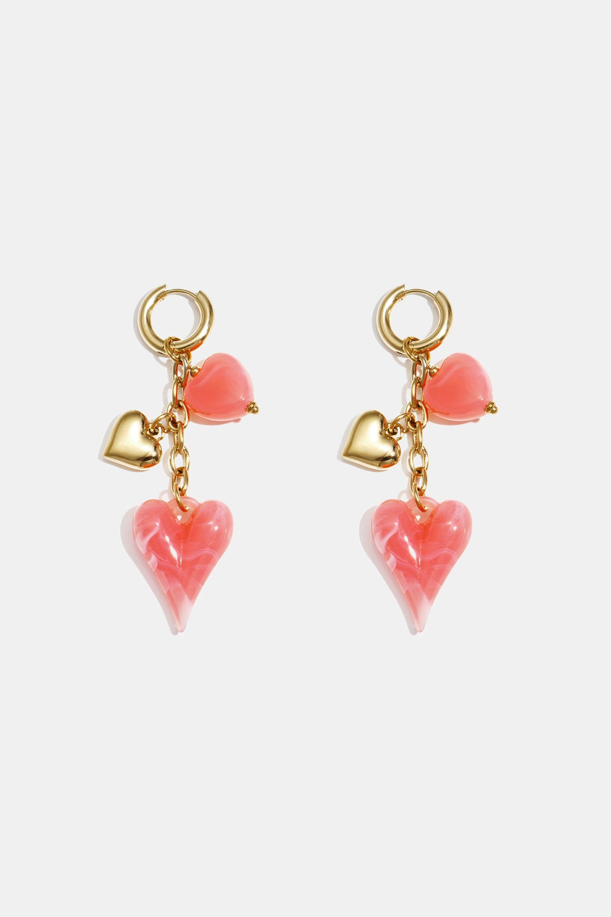 Gold hoop earrings with dangling pink and gold heart charms.