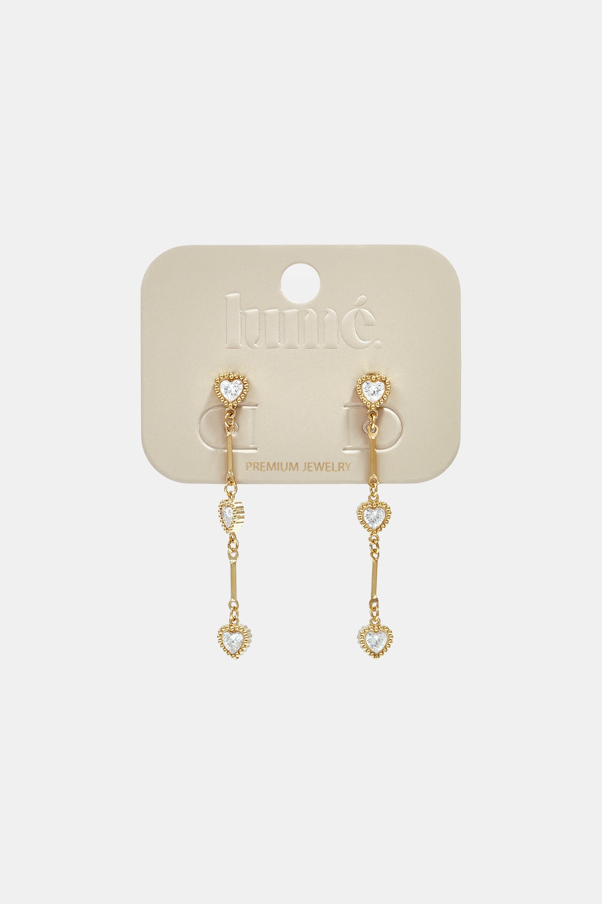 Gold dangle earrings with heart-shaped zircon charms hanging from a bar.