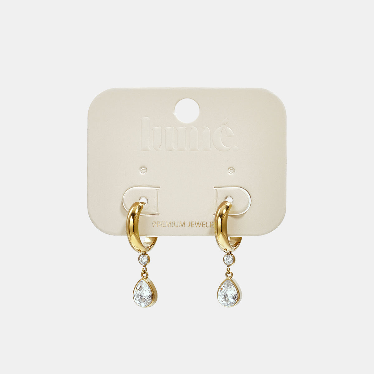 Gold hoop earrings with a dangling pear-shaped zircon and a smaller round zircon.